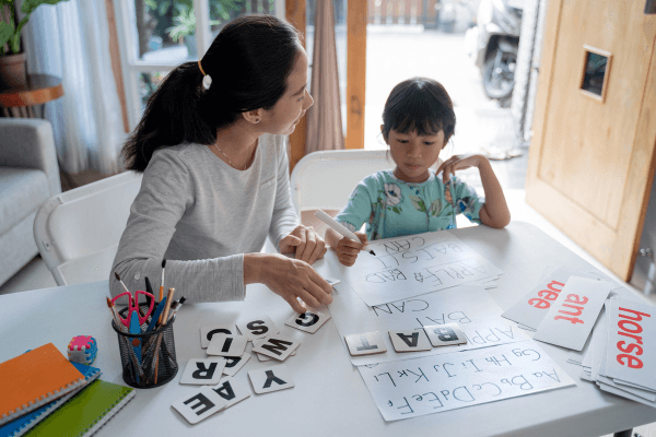 Mother and son doing a homeschool lesson at the table